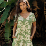 woman wearing green romper with native Hawaiian plants