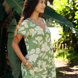 woman wearing green romper with native Hawaiian plants