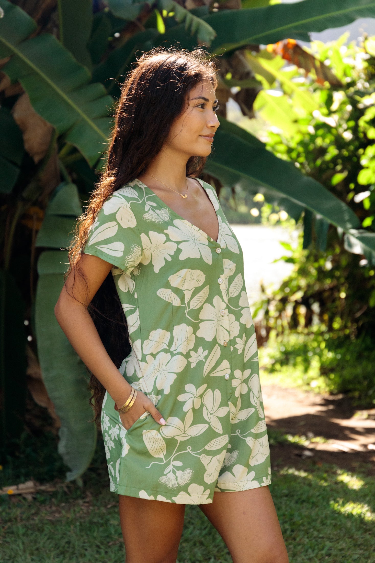 woman wearing green romper with native Hawaiian plants