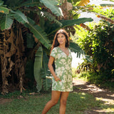 woman wearing green romper with native Hawaiian plants