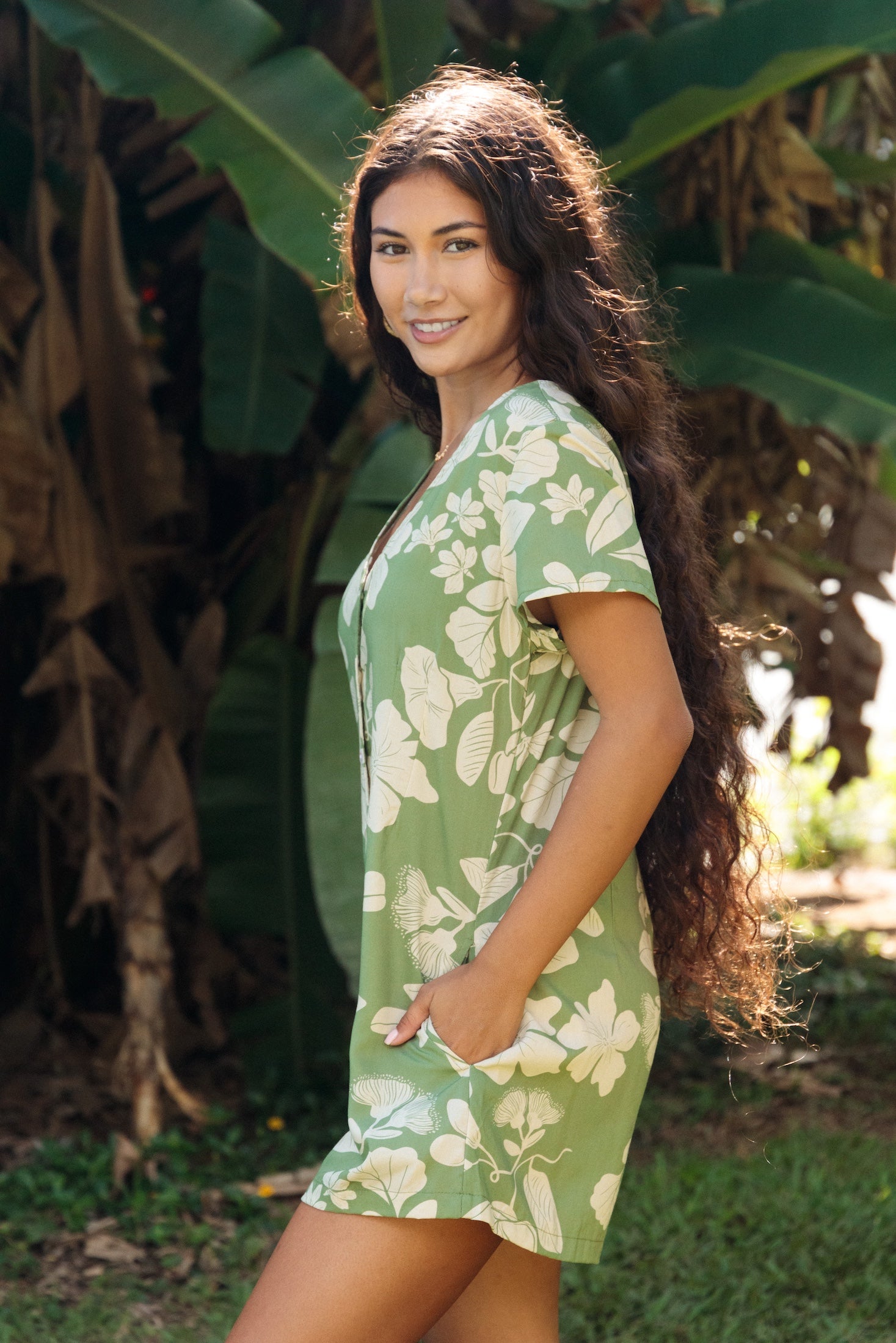 woman wearing green romper with native Hawaiian plants