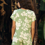 woman wearing green romper with native Hawaiian plants