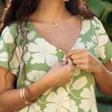 woman wearing green romper with native Hawaiian plants
