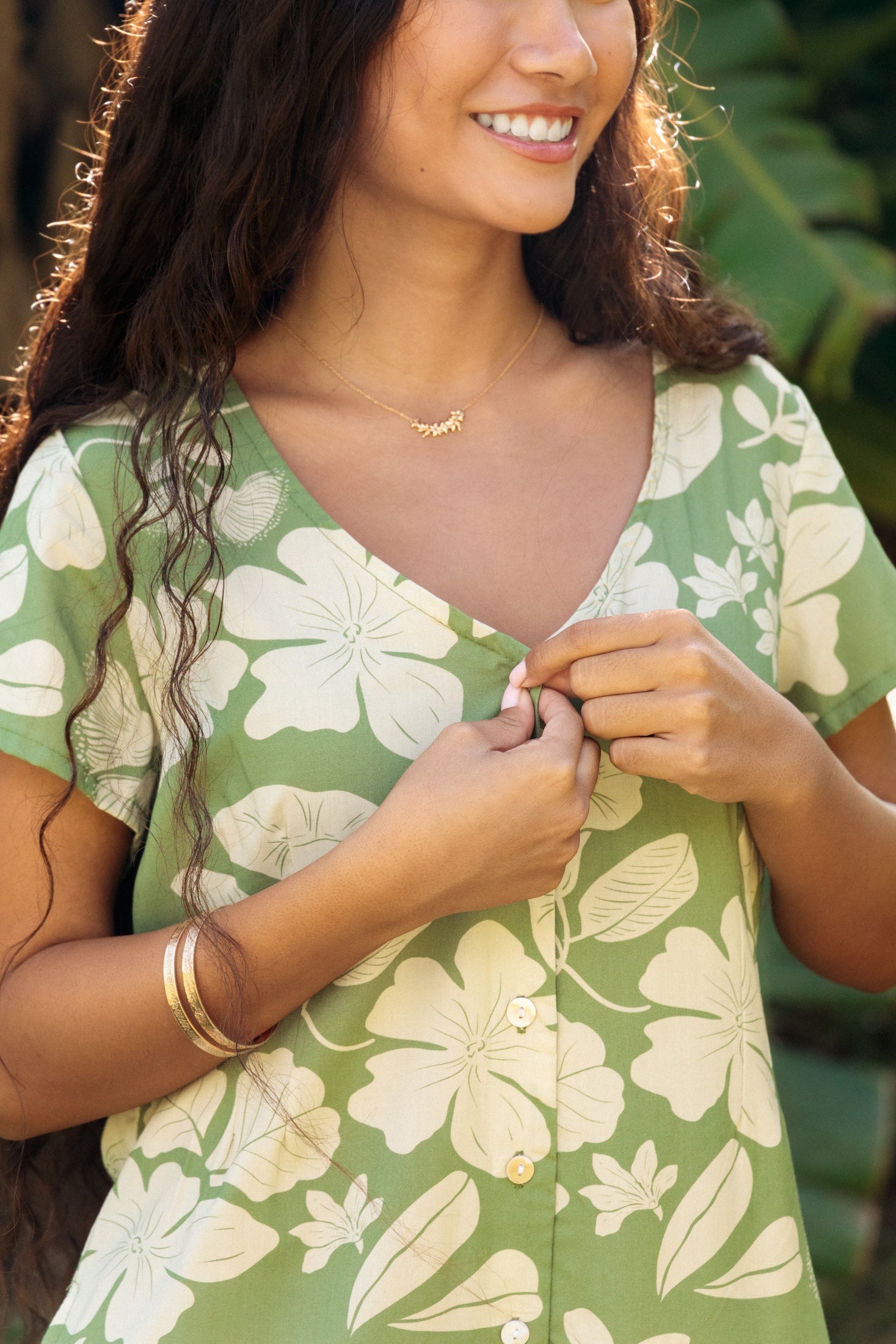 woman wearing green romper with native Hawaiian plants