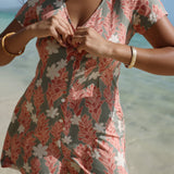 woman with brown hair wearing a jade colored button up romper with tiare ginger print
