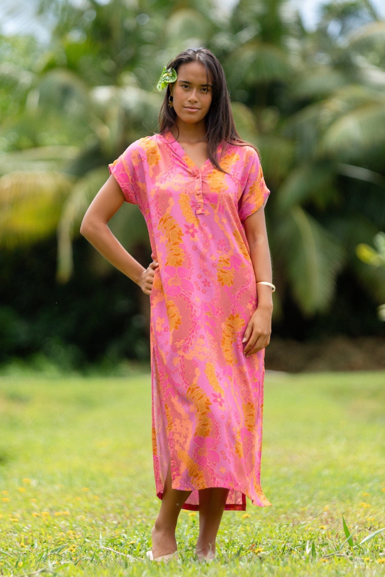 woman wearing a pink v neck maxi dress with lei print