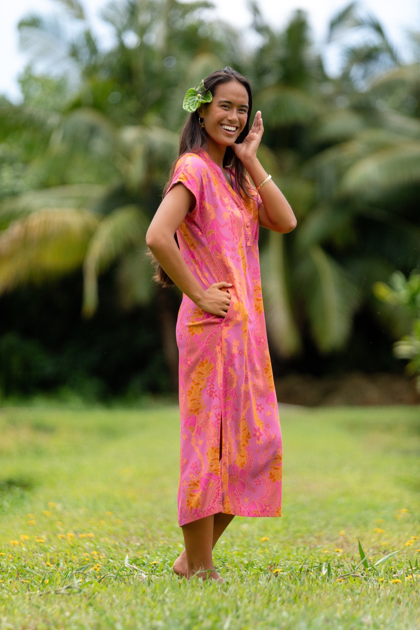 woman wearing a pink v neck maxi dress with lei print