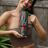 green tumbler with shell lei print