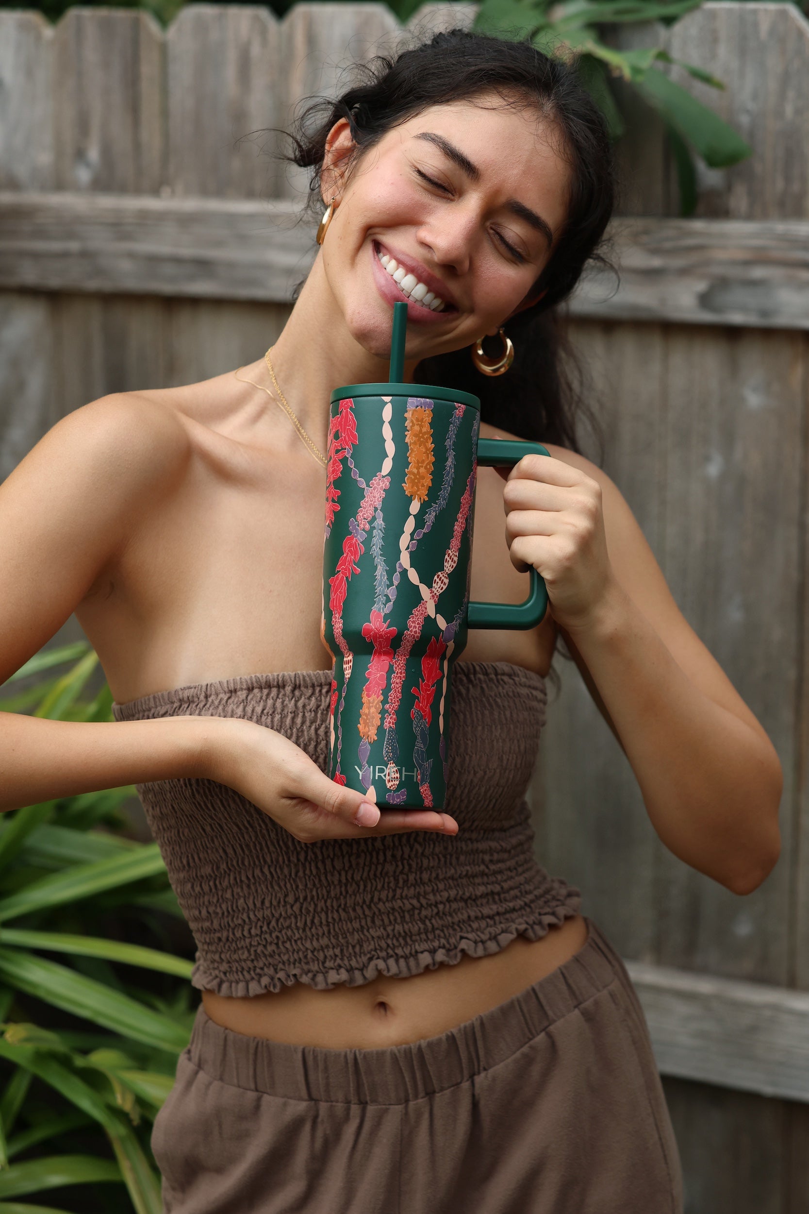 green tumbler with shell lei print