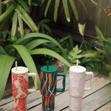 green tumbler with shell lei print