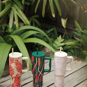 green tumbler with shell lei print