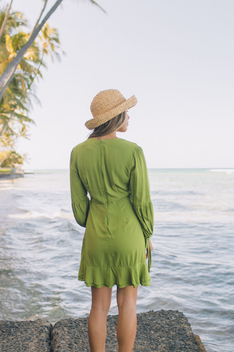 The Yireh Aster Dress in basil. Romantic and feminine silhouette. This is a classic Yireh style featuring flowing sleeves with a tie at the wrist and a zipper closure in back. Part of our limited run of solids, perfect to transition from day to night. Ethically and sustainably made resort wear.