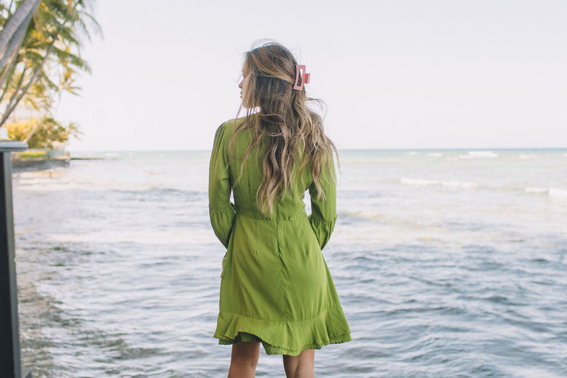 The Yireh Aster Dress in basil. Romantic and feminine silhouette. This is a classic Yireh style featuring flowing sleeves with a tie at the wrist and a zipper closure in back. Part of our limited run of solids, perfect to transition from day to night. Ethically and sustainably made resort wear.