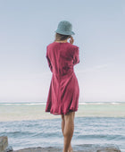 The Yireh Aster Dress in berry. Romantic and feminine silhouette. This is a classic Yireh style featuring flowing sleeves with a tie at the wrist and a zipper closure in back. Part of our limited run of solids, perfect to transition from day to night. Ethically and sustainably made resort wear.