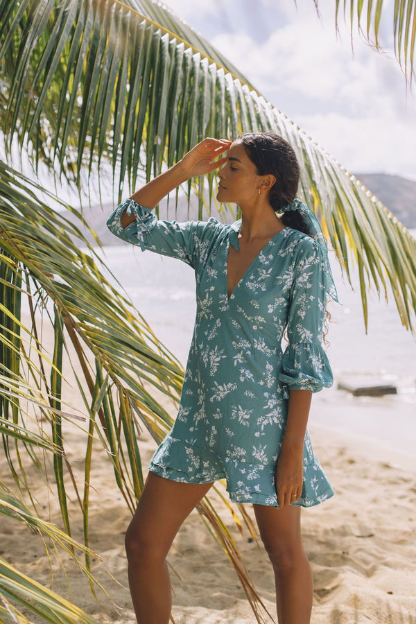 The Yireh Aster Dress in Lagoon. Romantic and feminine silhouette. This is a classic Yireh style featuring flowing sleeves with a tie at the wrist and a zipper closure in back. One of kind and exclusive Yireh print. Ethically and sustainably made resort wear.