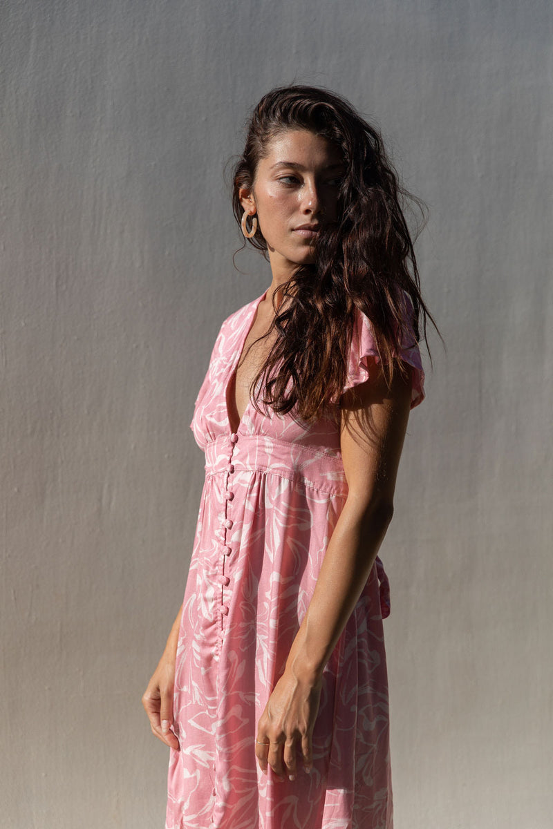 The Yireh Brynn Dress in Petal. A very flattering and versatile dress featuring covered buttons down the front and a tie back. Ethically and sustainably made with exclusive one of a kind prints.