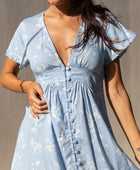 The Yireh Brynn Dress in Sky. A very flattering and versatile dress featuring covered buttons down the front and a tie back. Ethically and sustainably made with exclusive one of a kind prints.