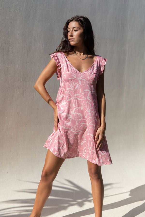 The Yireh Capri Dress in Petal. A romantic style featuring an A-line silhouette, a zipper back, and ruffles around the sleeves. This dress was ethically and sustainably made and features an exclusive one of a kind print. 