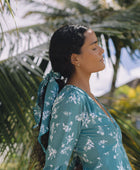 The Yireh Aster Dress in Lagoon. Romantic and feminine silhouette. This is a classic Yireh style featuring flowing sleeves with a tie at the wrist and a zipper closure in back. One of kind and exclusive Yireh print. Ethically and sustainably made resort wear.